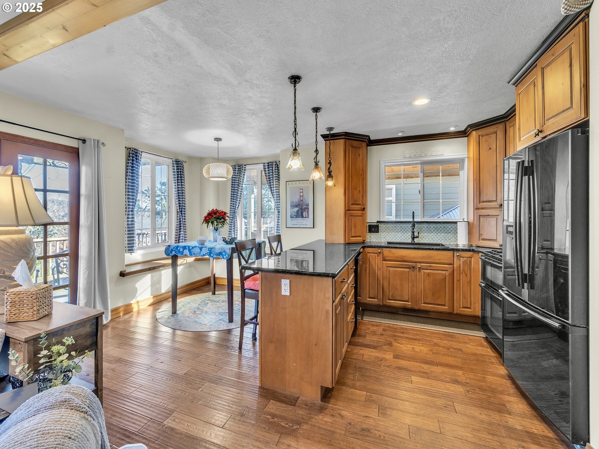 90589 Clark Road Warrenton, OR 97146 - Photo 29 of 48 a large kitchen with stainless steel appliances wooden floors and large window
