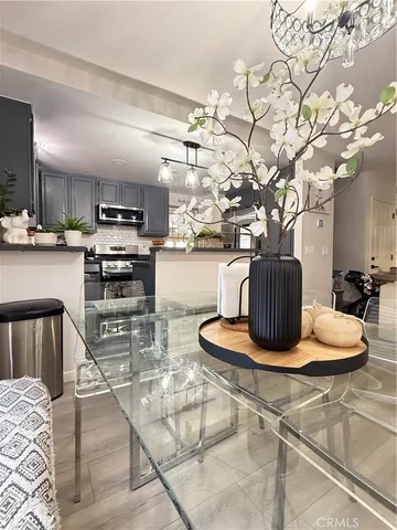 a kitchen with stainless steel appliances granite countertop a sink a stove and wooden floor