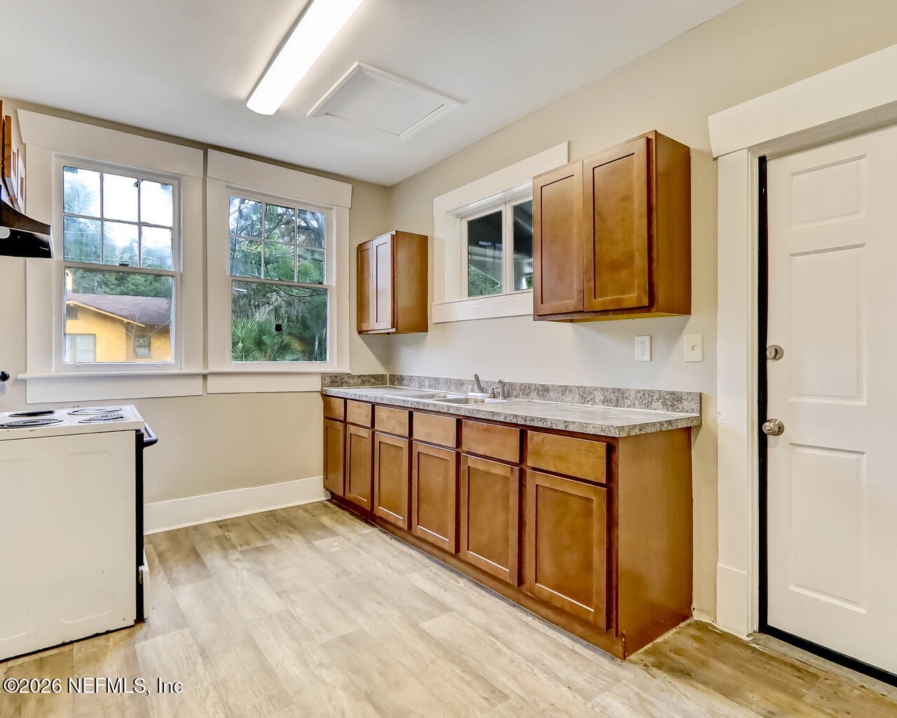 4325 Springfield Boulevard Jacksonville, FL 32206 - Photo 17 of 33 a kitchen with stainless steel appliances granite countertop a stove a sink and a refrigerator with wooden cabinets