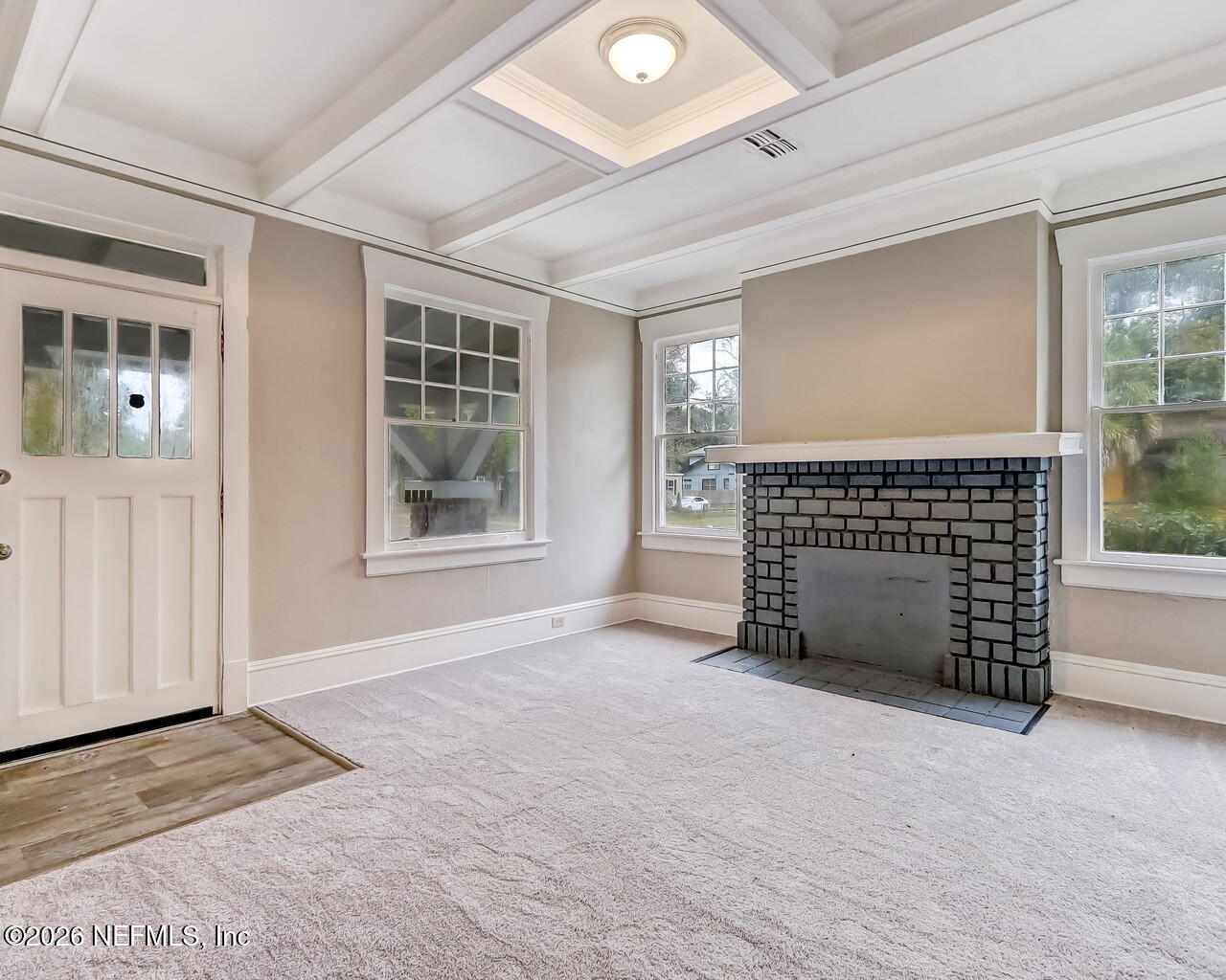 4325 Springfield Boulevard Jacksonville, FL 32206 - Photo 7 of 33 a view of an empty room with a fireplace and a window