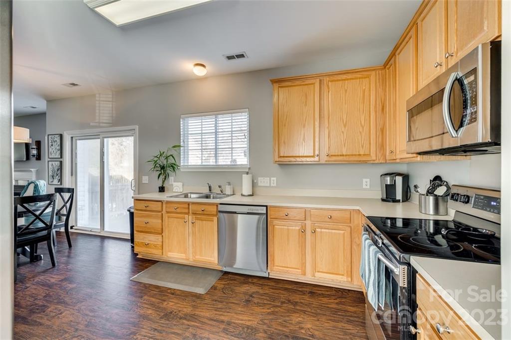 106 Anchura Road Fort Mill, SC 29708 - Photo 12 of 30 a kitchen with stainless steel appliances granite countertop a stove a sink and a microwave