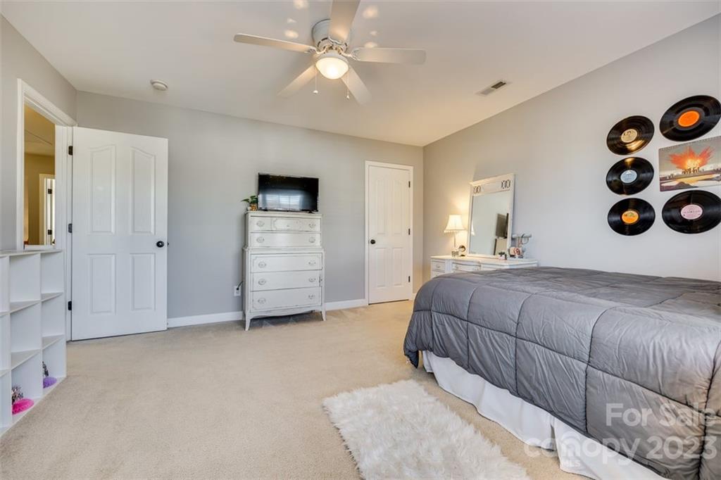 106 Anchura Road Fort Mill, SC 29708 - Photo 21 of 30 a bedroom with a bed and a cabinets