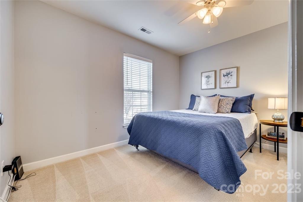 106 Anchura Road Fort Mill, SC 29708 - Photo 22 of 30 a bedroom with a bed and a chandelier