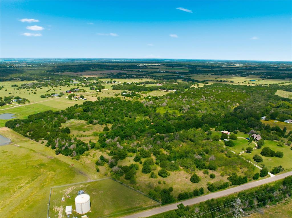 663 North Katy Road Elm Mott, TX 76640 - Photo 4 of 25 Rural landscape featuring a mix of open fields and densely wooded areas