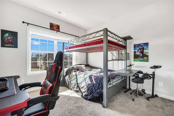 a bedroom with furniture and a window