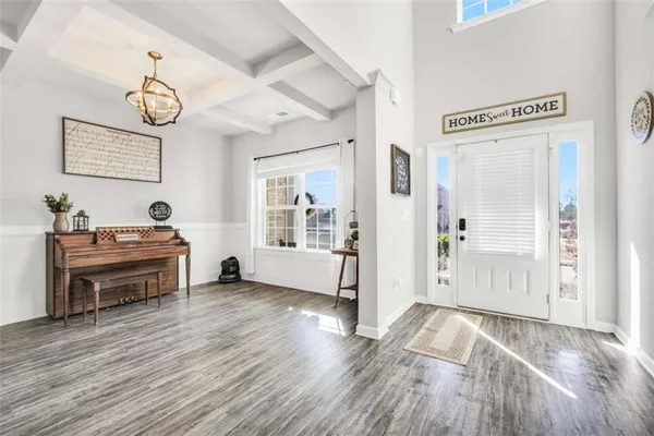 a view of a room with wooden floor and white walls