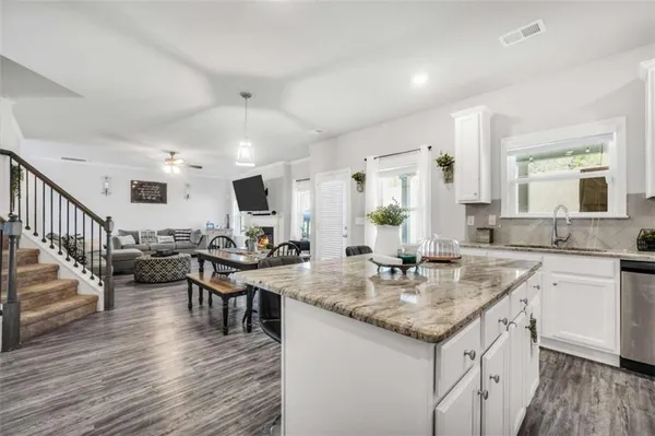 a kitchen with lots of counter top space and living room