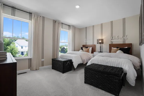 a bedroom with two beds and a large window