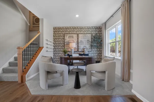 a dining room with wooden floor and a large window