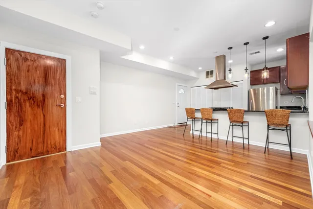 a view of kitchen and dining room with wooden floor