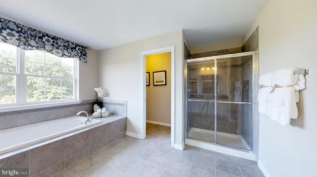 a spacious bathroom with a bathtub and a shower