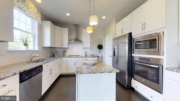 a kitchen with a sink stove and microwave