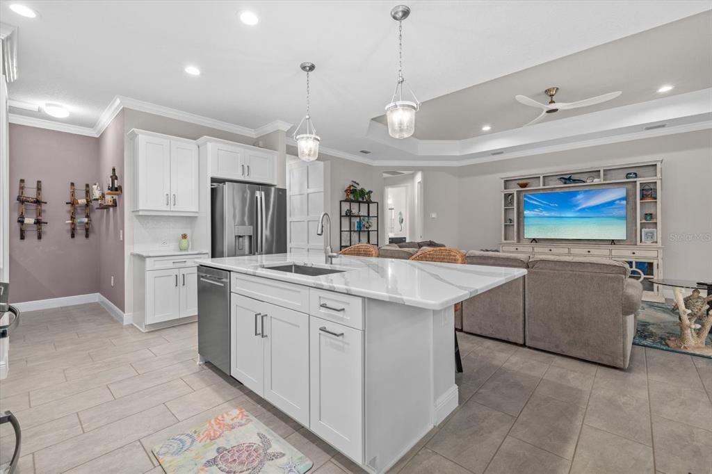13185 Steinhatchee Loop Venice, FL 34293 - Photo 24 of 50 a large kitchen with cabinets and a stove