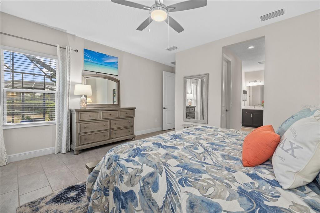 13185 Steinhatchee Loop Venice, FL 34293 - Photo 30 of 50 a bedroom with a large bed and a window