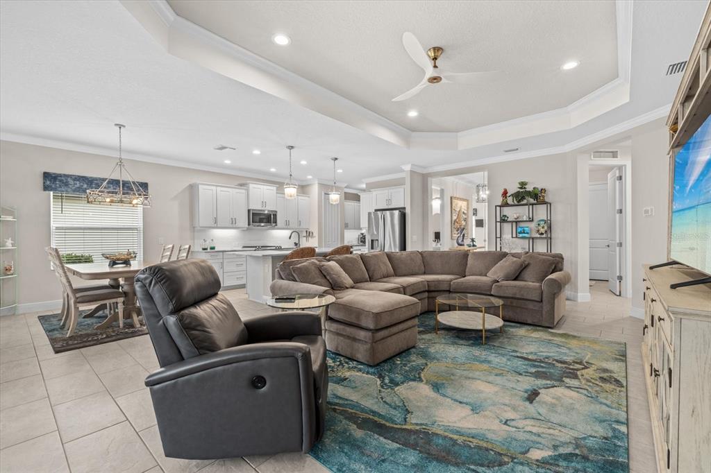 13185 Steinhatchee Loop Venice, FL 34293 - Photo 33 of 50 a living room with furniture kitchen view and a chandelier