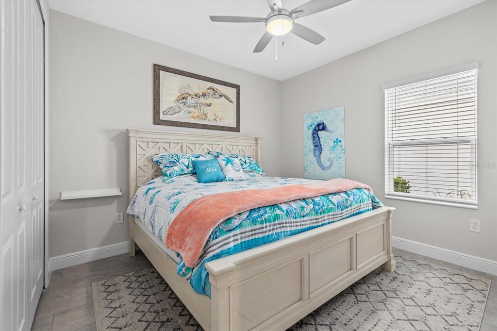 13185 Steinhatchee Loop Venice, FL 34293 - Photo 37 of 50 a bed sitting in a bedroom next to a window