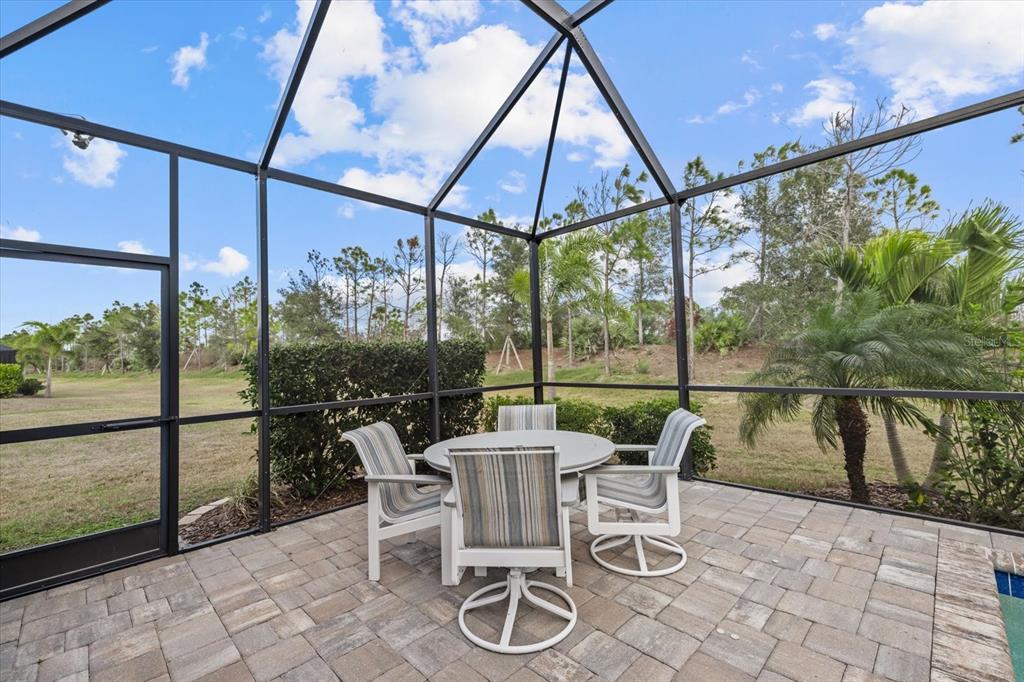 13185 Steinhatchee Loop Venice, FL 34293 - Photo 45 of 50 a patio with yard glass top table and chairs
