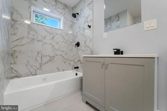 a bathroom with a bathtub and a shower