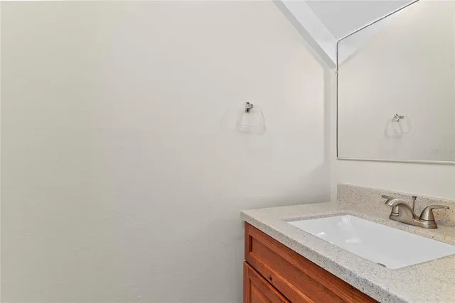 a bathroom with a granite countertop sink and vanity