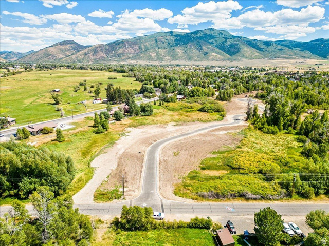 829 River Haven Road, Unit 111 Oakley, UT 84055 - Photo 11 of 12 Aerial perspective showcasing graded land with a paved cul-de-sac, surrounded by mature trees and natural vegetation