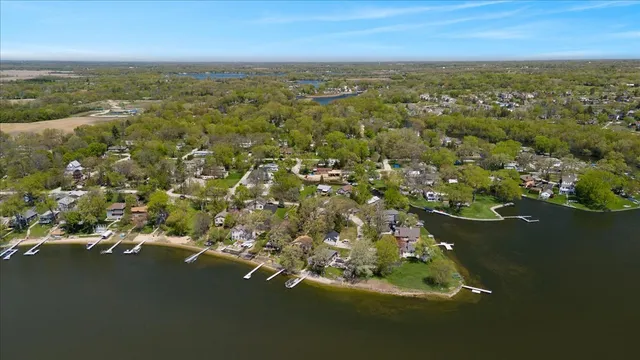 an aerial view of a houses with a lake view
