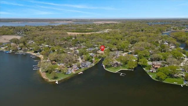 an aerial view of a house with a lake view