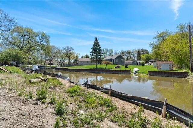 a view of a lake with houses in the back