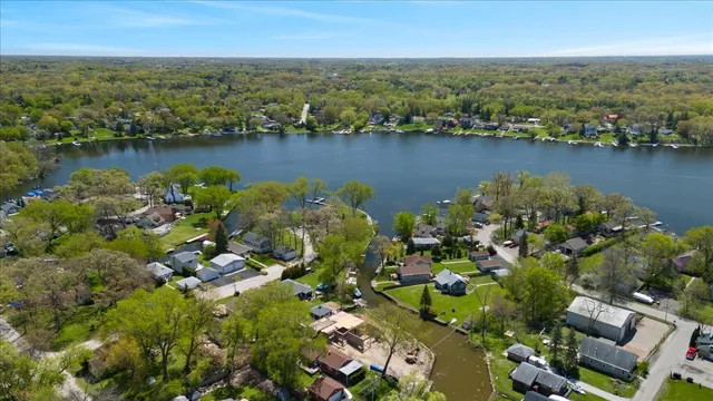 an aerial view of a houses with a lake view