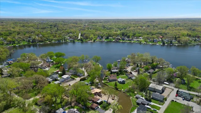 an aerial view of lake and residential houses with outdoor space