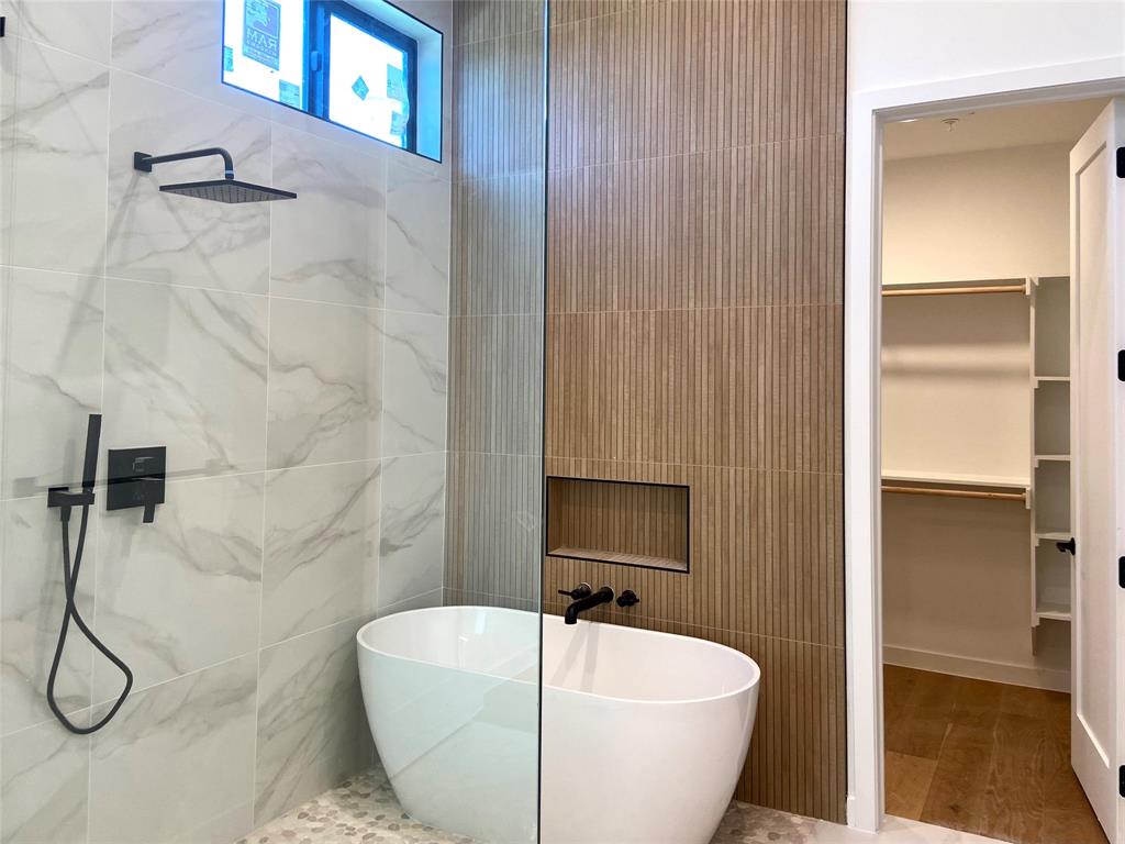 1111 Raiford Road, Unit 128 Carrollton, TX 75007 - Photo 6 of 18 Freestanding soaking tub within a glass-enclosed shower. Finishes that feel like a luxury hotel. (construction photos - professional photos upon completion)