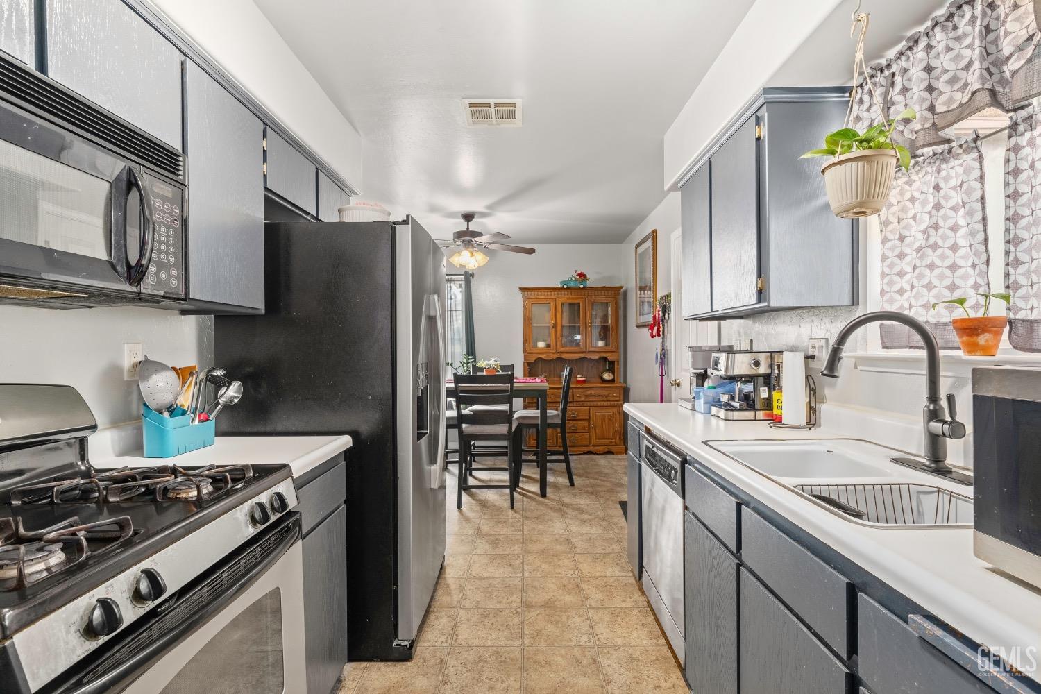 Undisclosed Address Arvin, CA 93203 - Photo 12 of 33 a kitchen with stainless steel appliances a sink a stove and a refrigerator