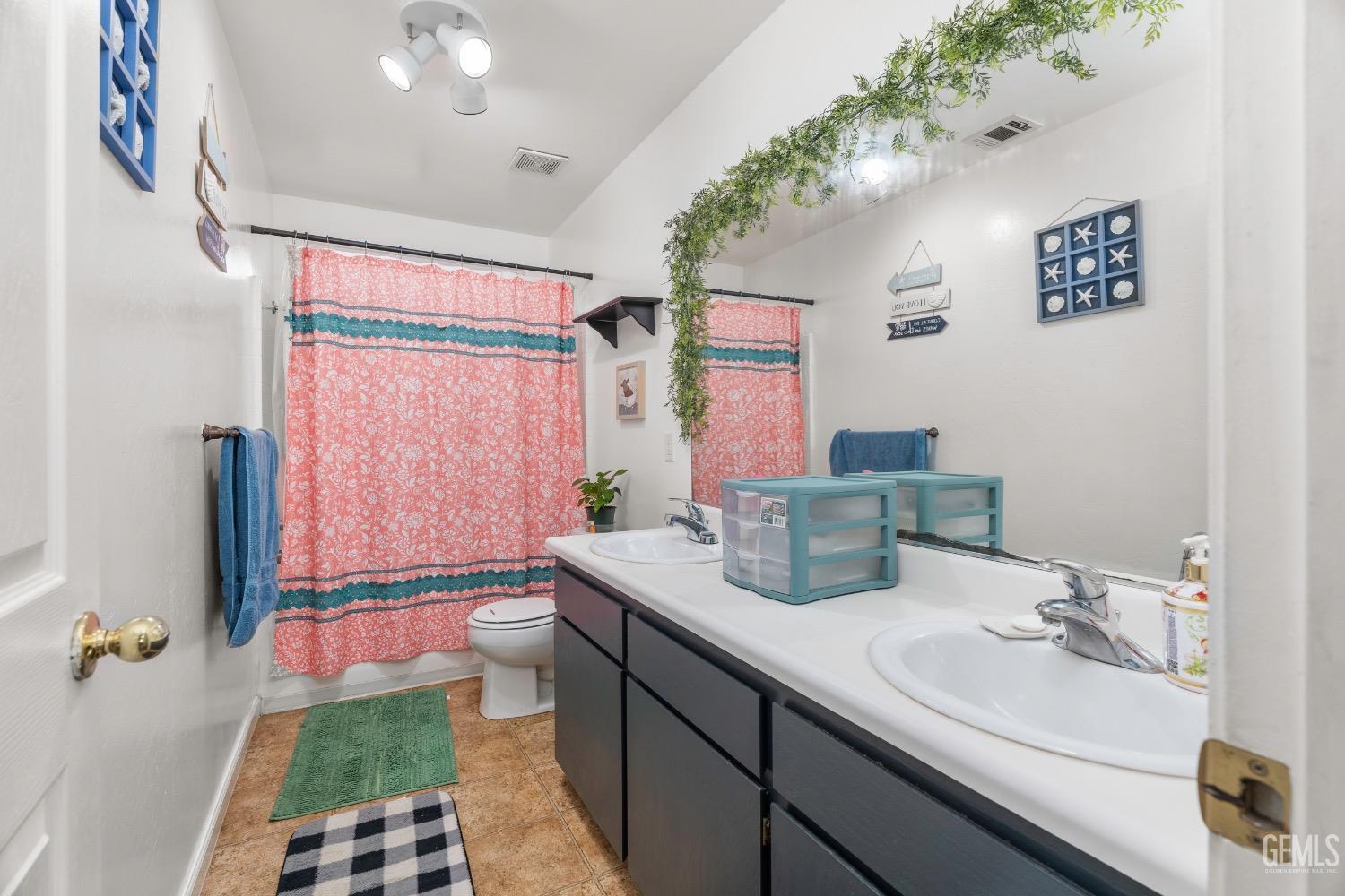 Undisclosed Address Arvin, CA 93203 - Photo 19 of 33 a bathroom with a double vanity sink toilet and shower