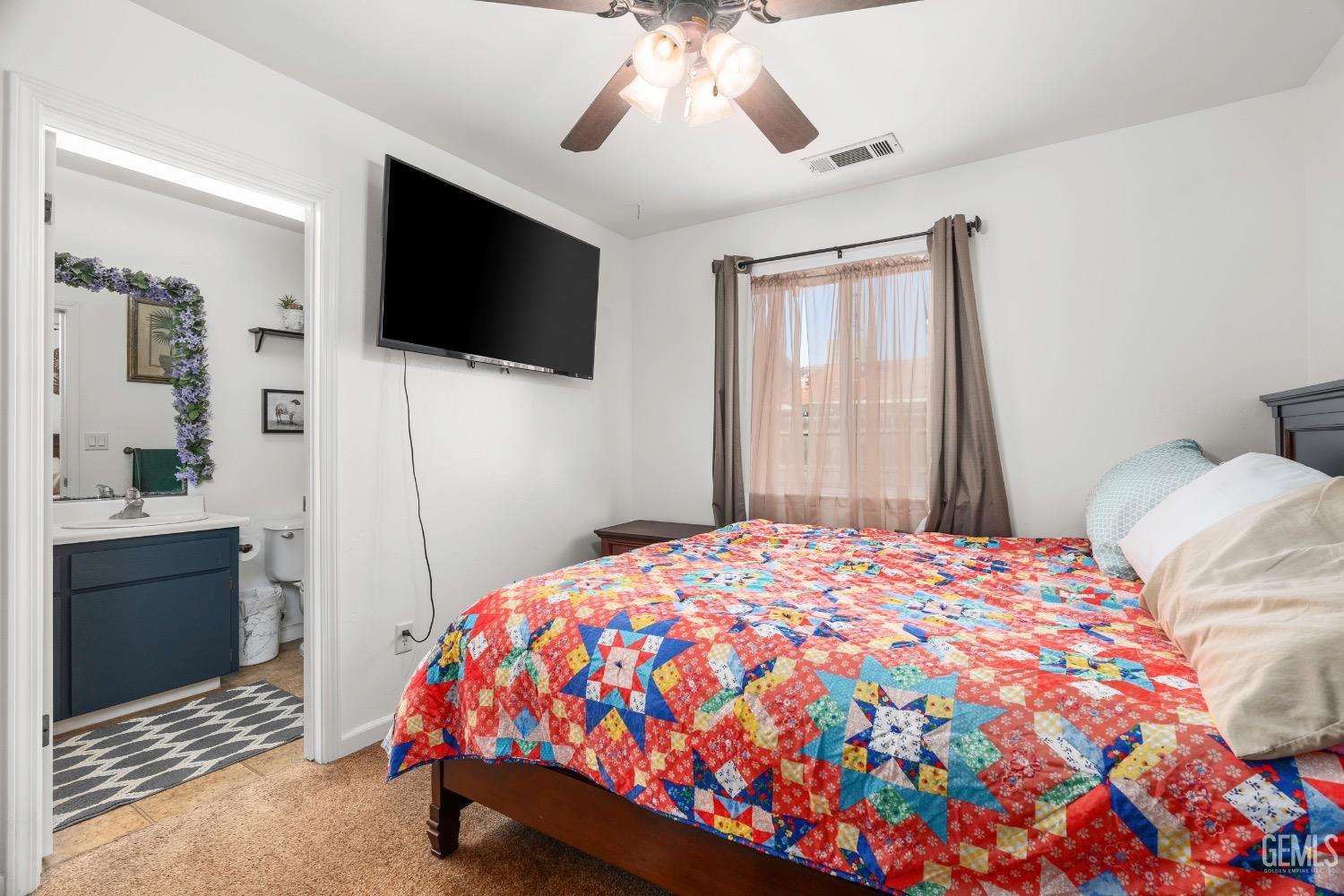 Undisclosed Address Arvin, CA 93203 - Photo 21 of 33 a bedroom with a bed and a flat screen tv