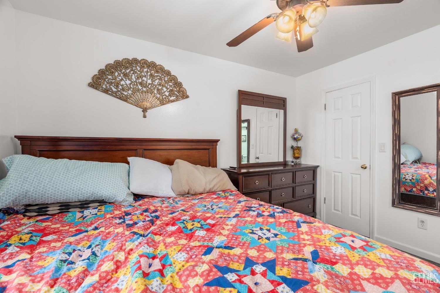 Undisclosed Address Arvin, CA 93203 - Photo 23 of 33 a bedroom with a bed and a chandelier