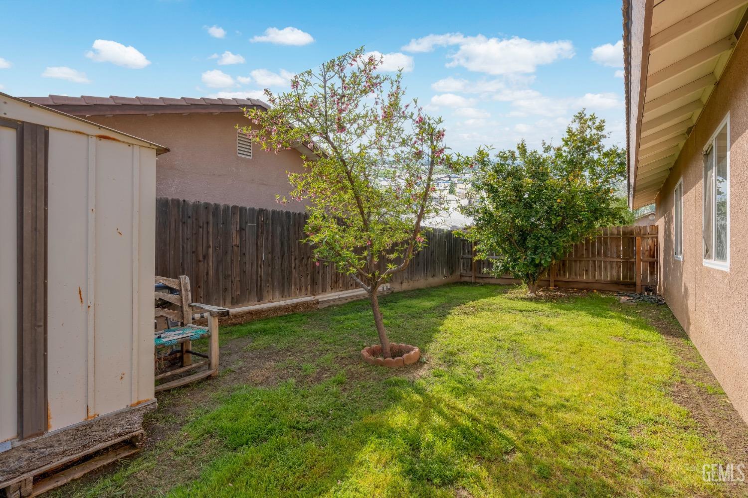 Undisclosed Address Arvin, CA 93203 - Photo 29 of 33 a backyard of a house with plants and wooden fence