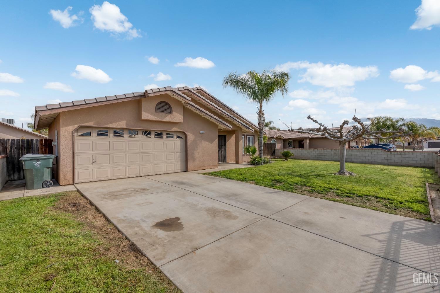 Undisclosed Address Arvin, CA 93203 - Photo 3 of 33 a front view of a house with a yard and garage