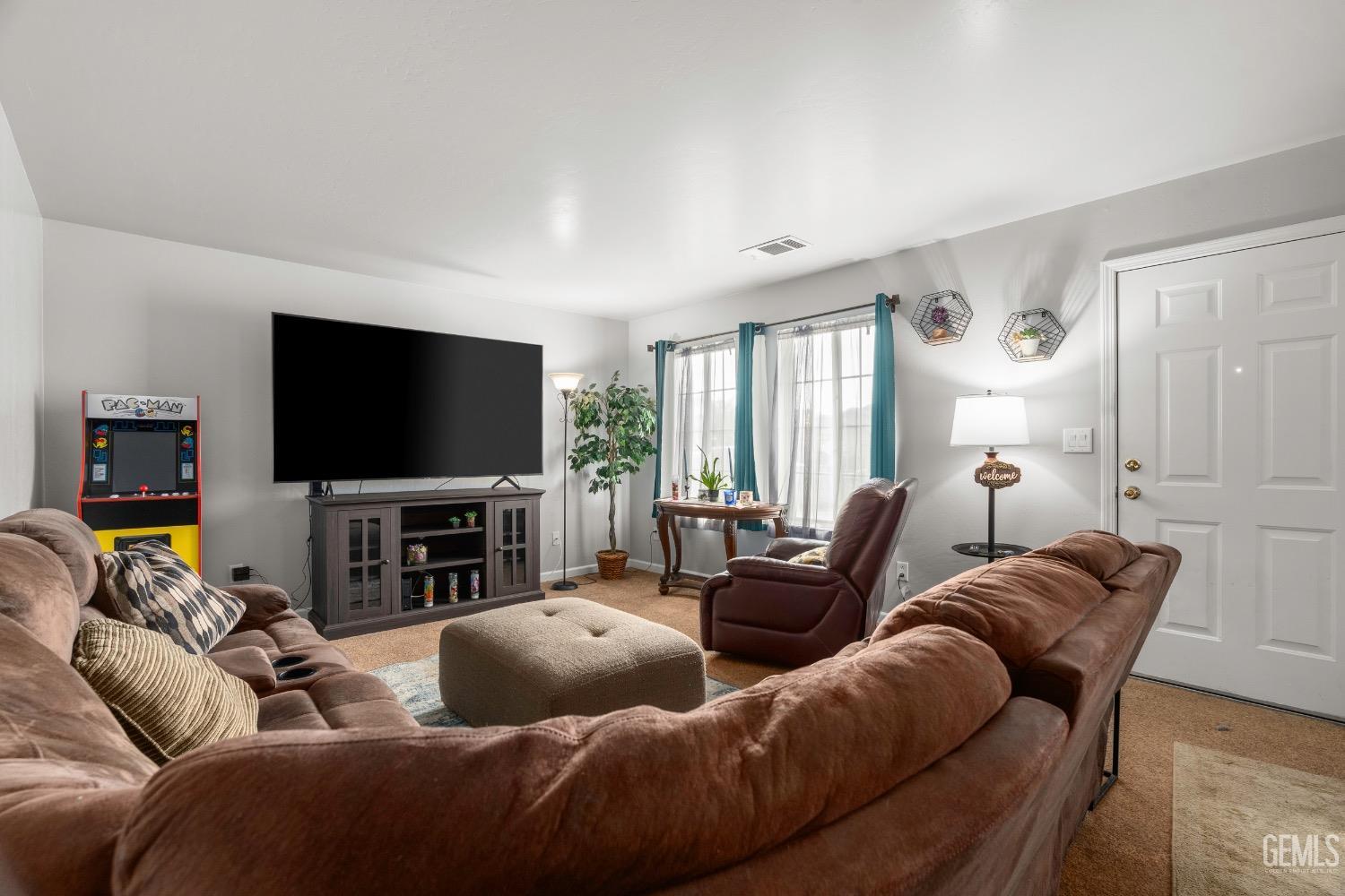 Undisclosed Address Arvin, CA 93203 - Photo 5 of 33 a living room with furniture and a flat screen tv