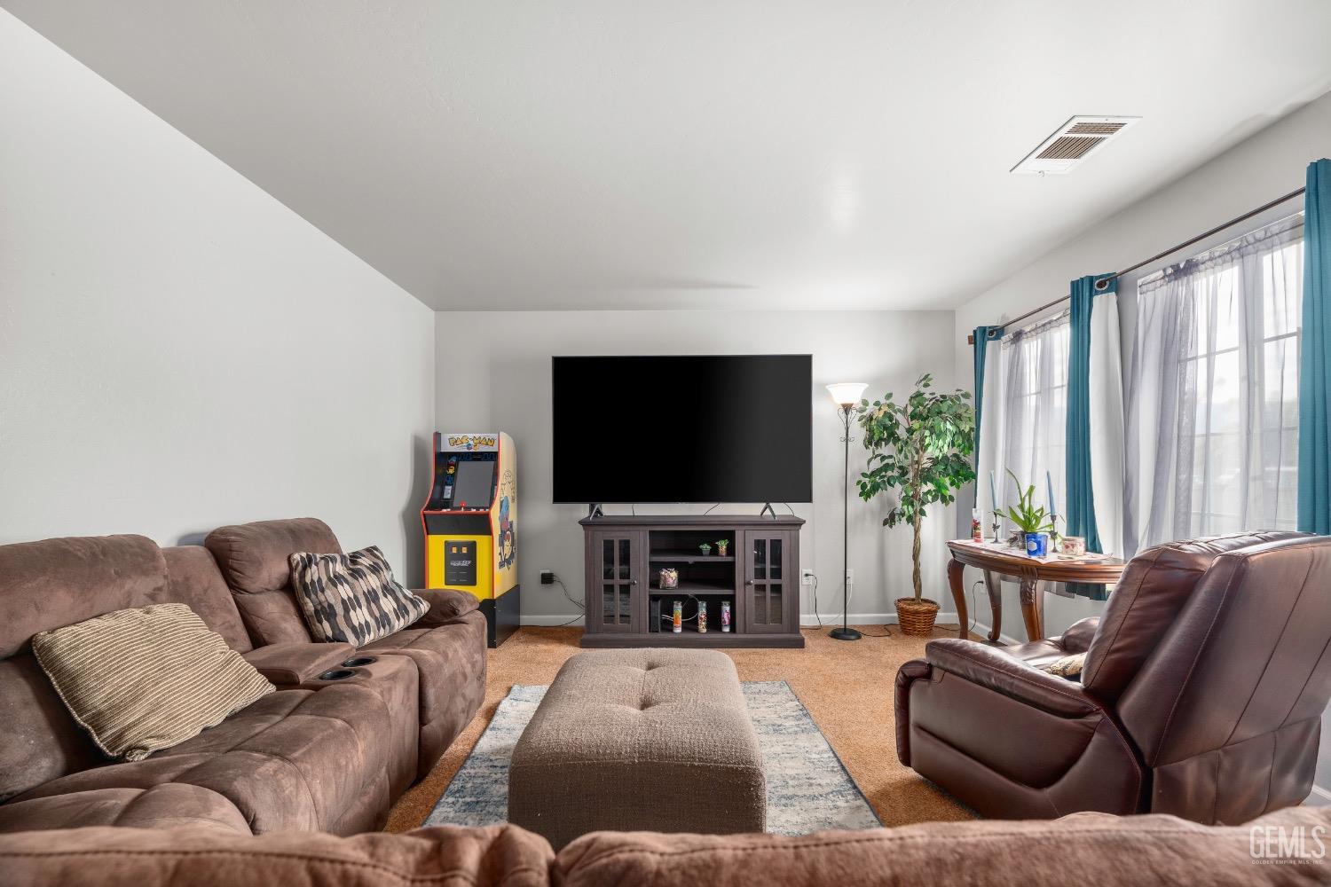 Undisclosed Address Arvin, CA 93203 - Photo 7 of 33 a living room with furniture and a flat screen tv