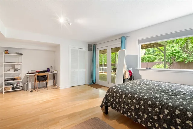 a bedroom with a bed and a large window with the outer view