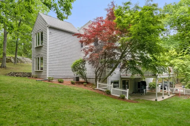 a view of a house with a yard and sitting area