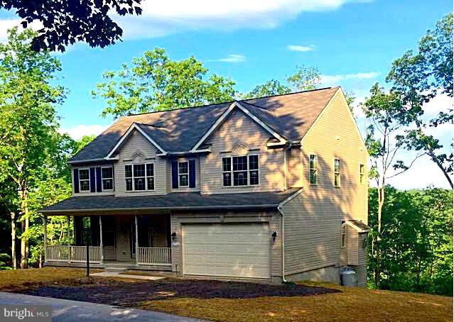 276 Ridgecrest Road New Market, MD 21774 - Photo 1 of 10 a view of a white house with large windows and a small yard