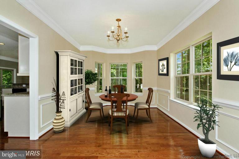 276 Ridgecrest Road New Market, MD 21774 - Photo 4 of 10 a dining room with wooden floor a chandelier a glass table and chairs