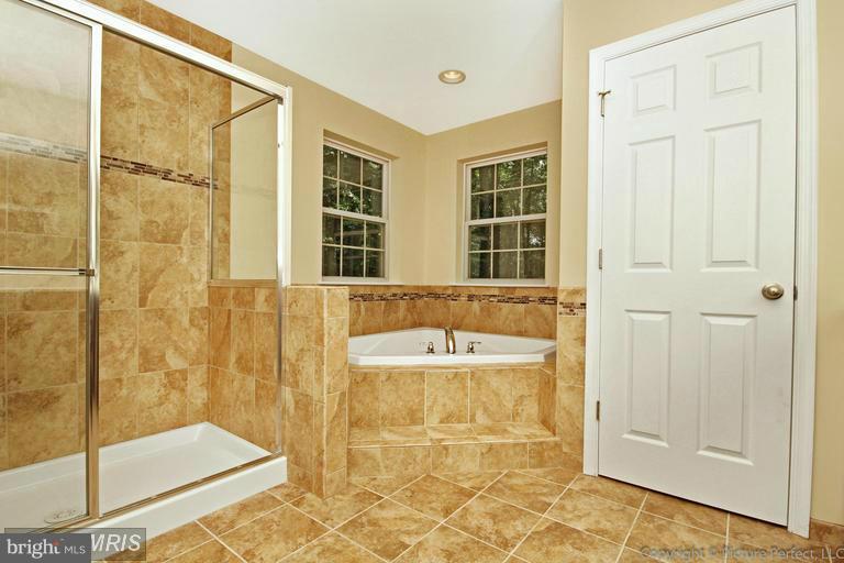276 Ridgecrest Road New Market, MD 21774 - Photo 8 of 10 a bathroom with a bathtub and a shower