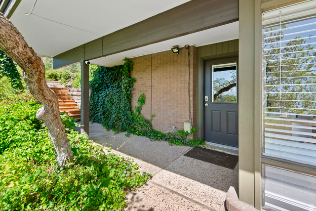 1900 North 100 East Provo, UT 84604 - Photo 42 of 49 Covered entry featuring a dark-paneled door with an upper window, leading to a textured concrete walkway