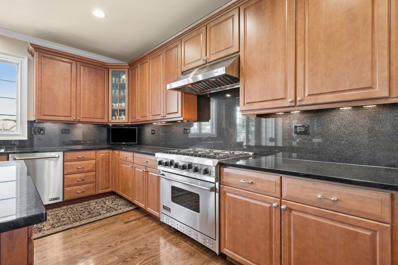 1029 Ridgeview Drive Inverness, IL 60010 - Photo 16 of 58 a kitchen with granite countertop wooden cabinets stainless steel appliances and a window