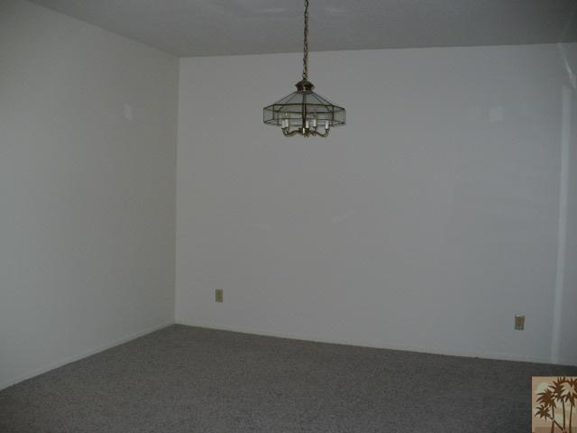 67360 Rango Road Cathedral City, CA 92234 - Photo 7 of 21 a view of a room with a hanging light and kitchen view