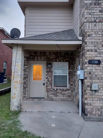 a front view of a building with the garden
