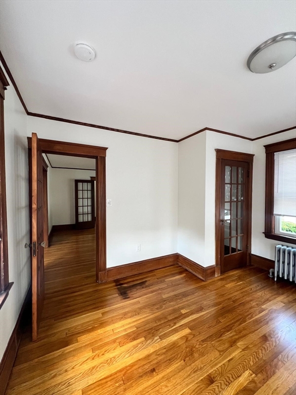 96 Brooks Street, Unit 1 Boston, MA 02135 - Photo 16 of 19 a view of empty room with wooden floor and fan