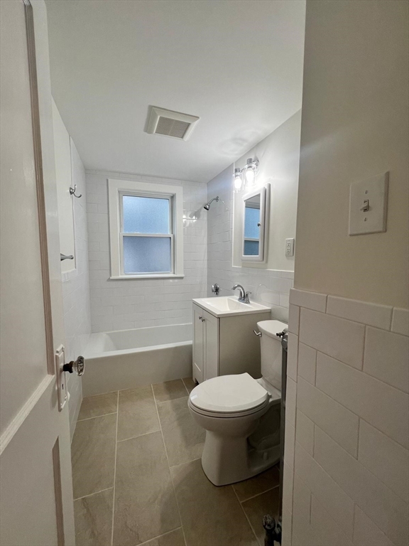 96 Brooks Street, Unit 1 Boston, MA 02135 - Photo 18 of 19 a bathroom with a toilet sink and mirror