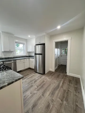 a kitchen with refrigerator and window